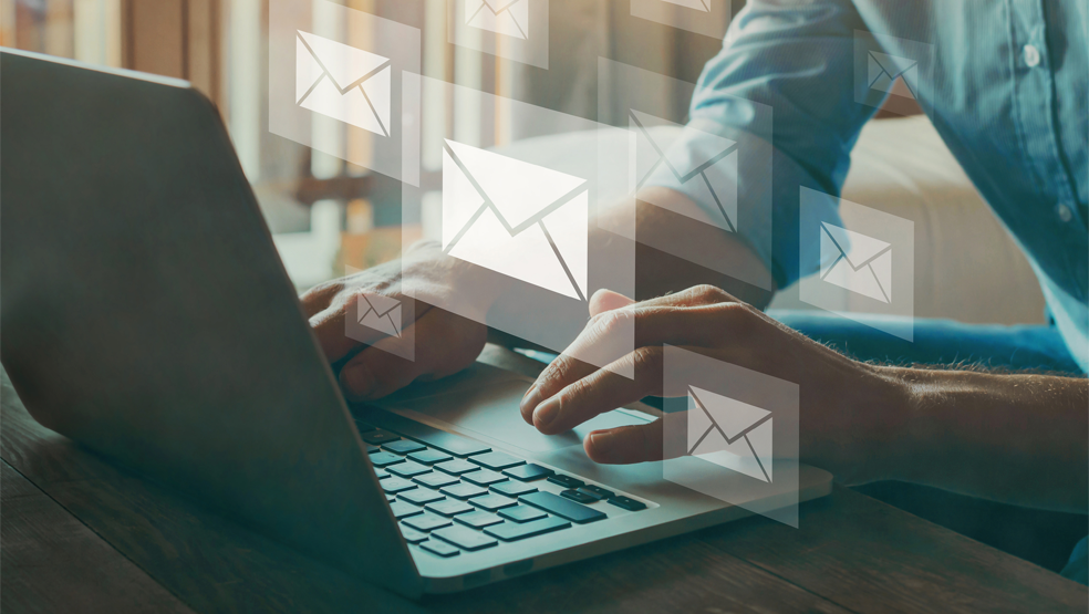 Person writing emails on a laptop